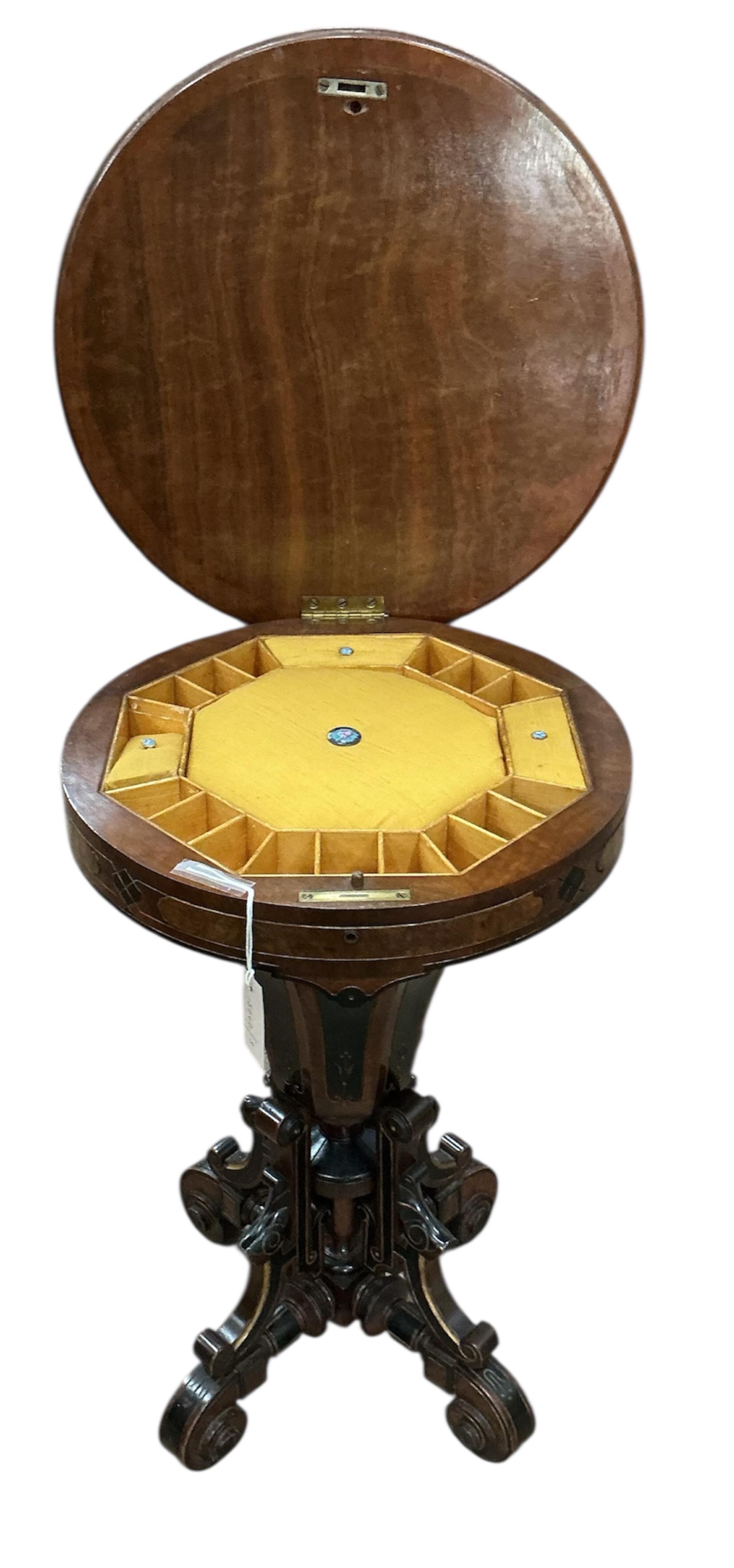 A Victorian circular ebonised amboyna work table, diameter 49cm, height 72cm